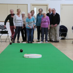Carpet Bowls Club Eco Hub picture of A group of 9 happy people playing carpet bowls