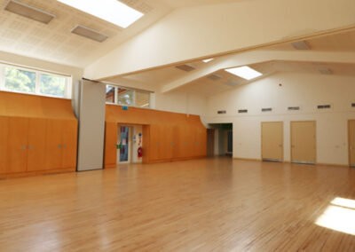 The Ellis Maddocks Hall a picture of our largest hall with high ceilings with skylights, wooden floor and doors to other rooms and outside space