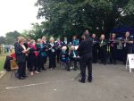 Picture of community choir singing outside on a grey day