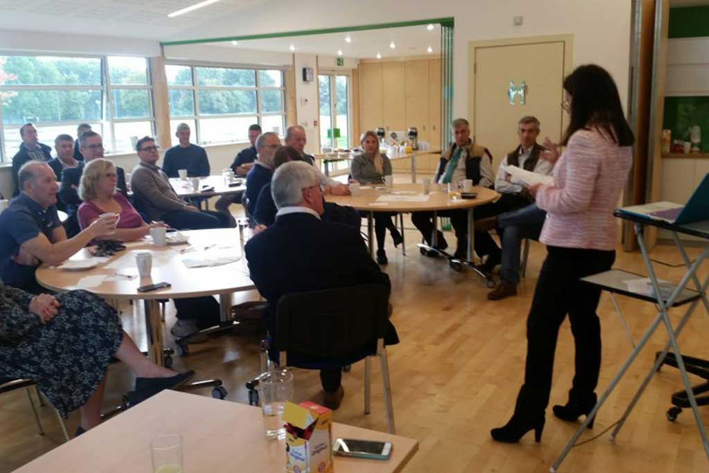 BusinessHub Meeting with people sitting and standing around in the hall