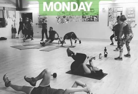 People doing a rande of fitness activities, some on mats on the floor, some swinging kettlebells around. Text saying "Never Miss A Monday" and "#PTJoolz"
