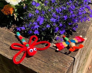 some insects made from pipecleaners and pompoms.